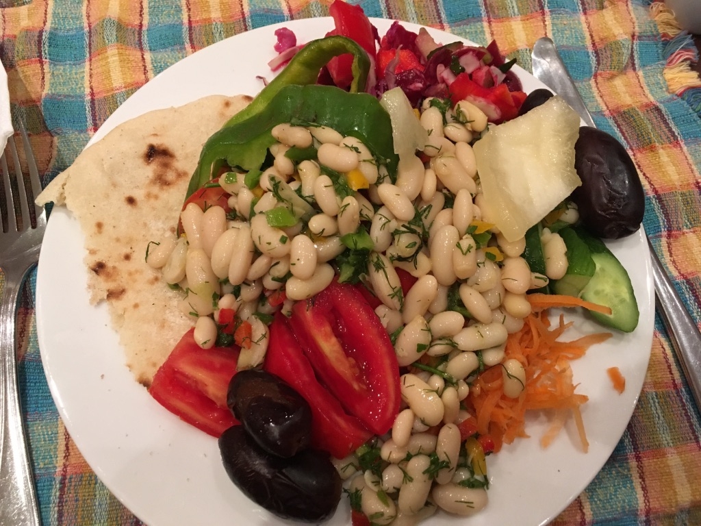 A vegan lunch example from the hotel buffet with beans, vegetables, dates, salad