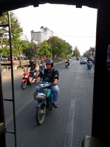 East side of Chang Mia's circular moat road. View of mopeds taken from Songtaew bahtbus