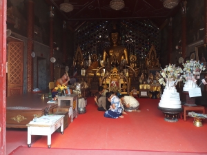 Buddhit Monk blessing kneeling worshipers