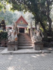 Temple at Wat Pha Lat as viewed from lower level with stars and statues either side