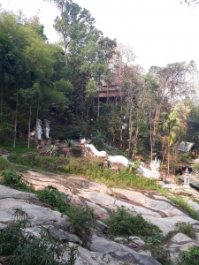 Shot showing part of Wat Pha Lat compex buried in the jungle